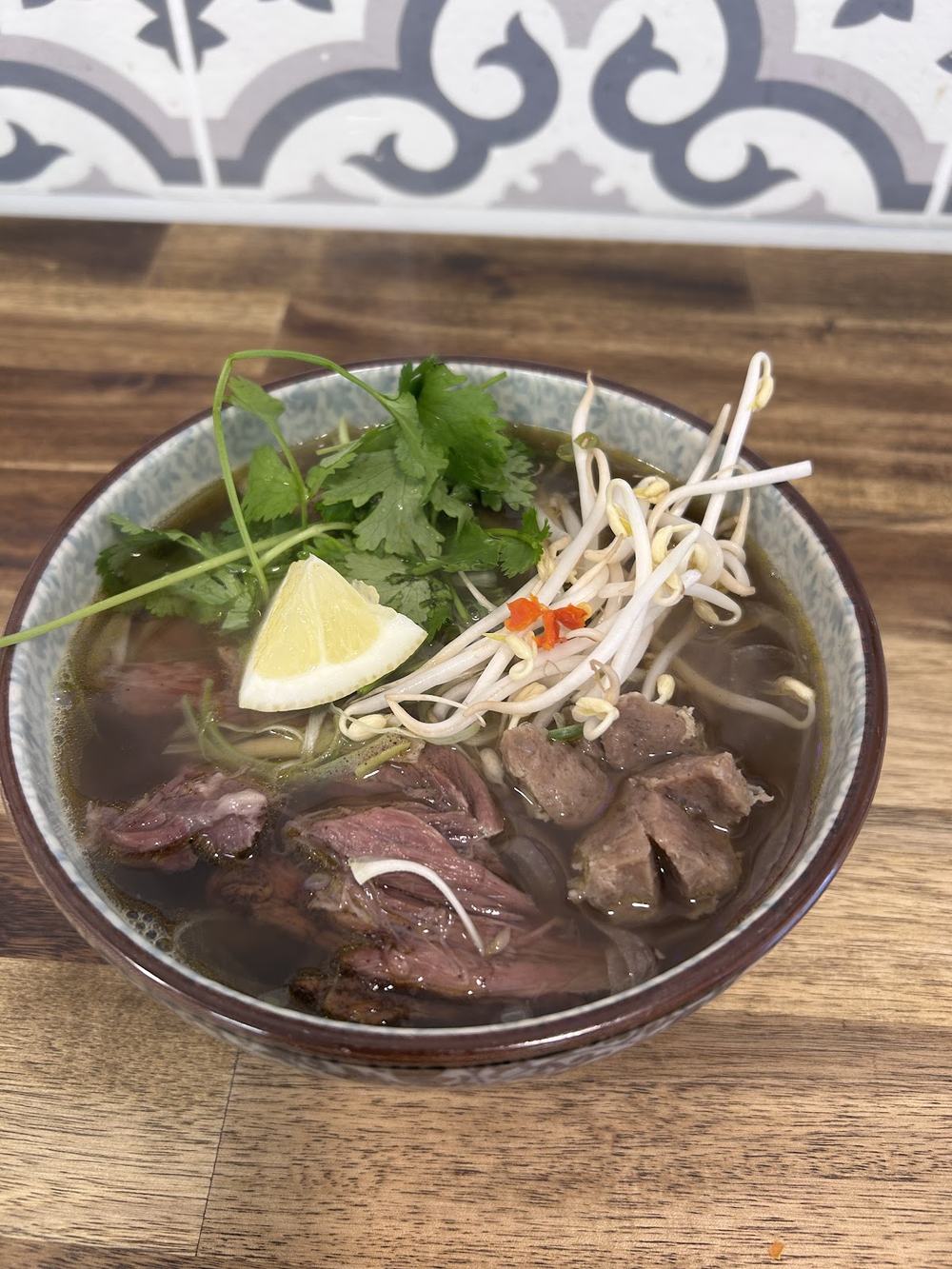 Beef phở on a wooden table